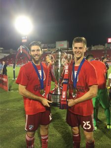 Placer alumni player, Ryan Hollingshead (left) with the US Open Cup Trophy
